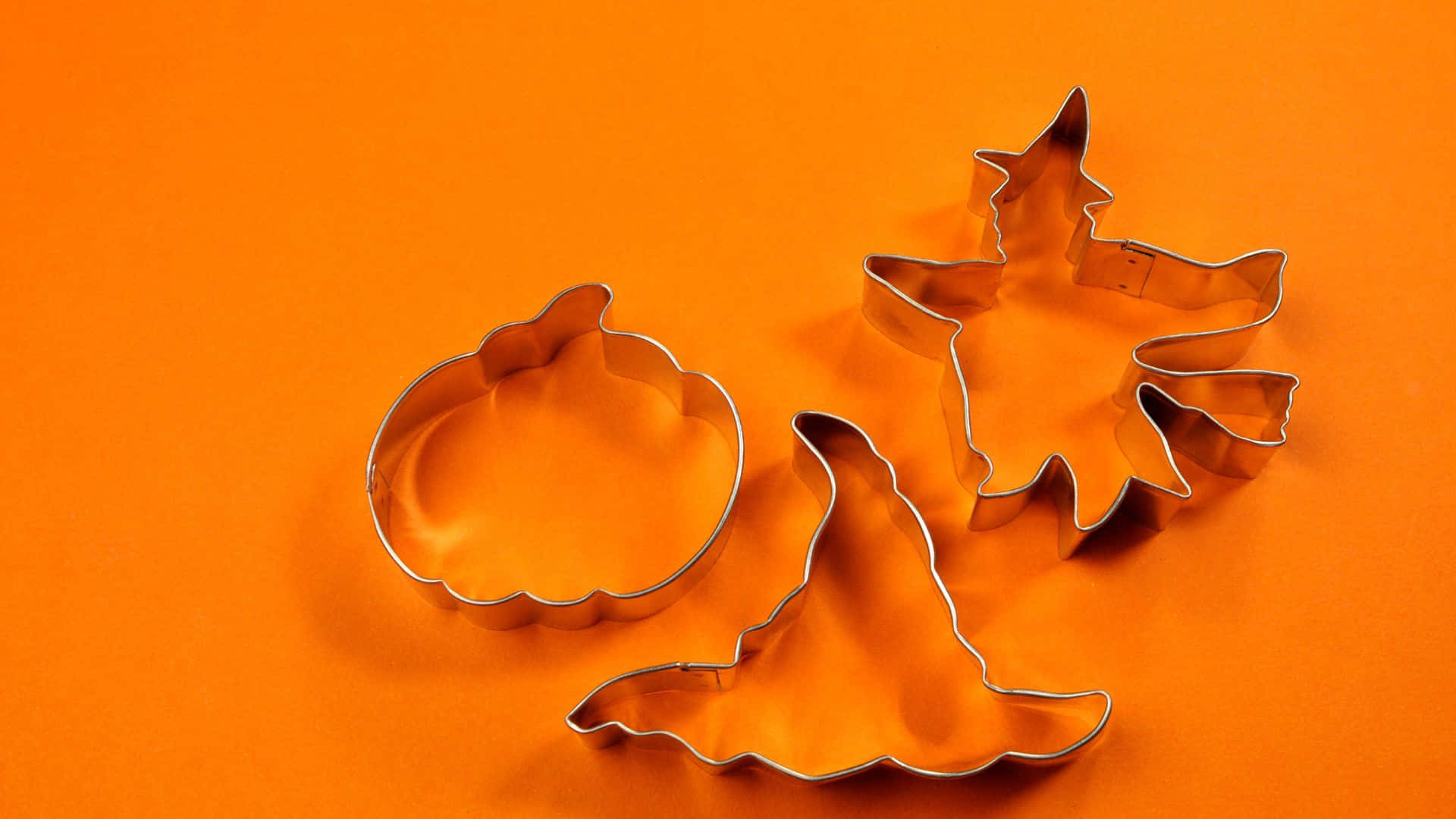 Unleash your inner baker this Halloween with festive cookie cutters! Wallpaper