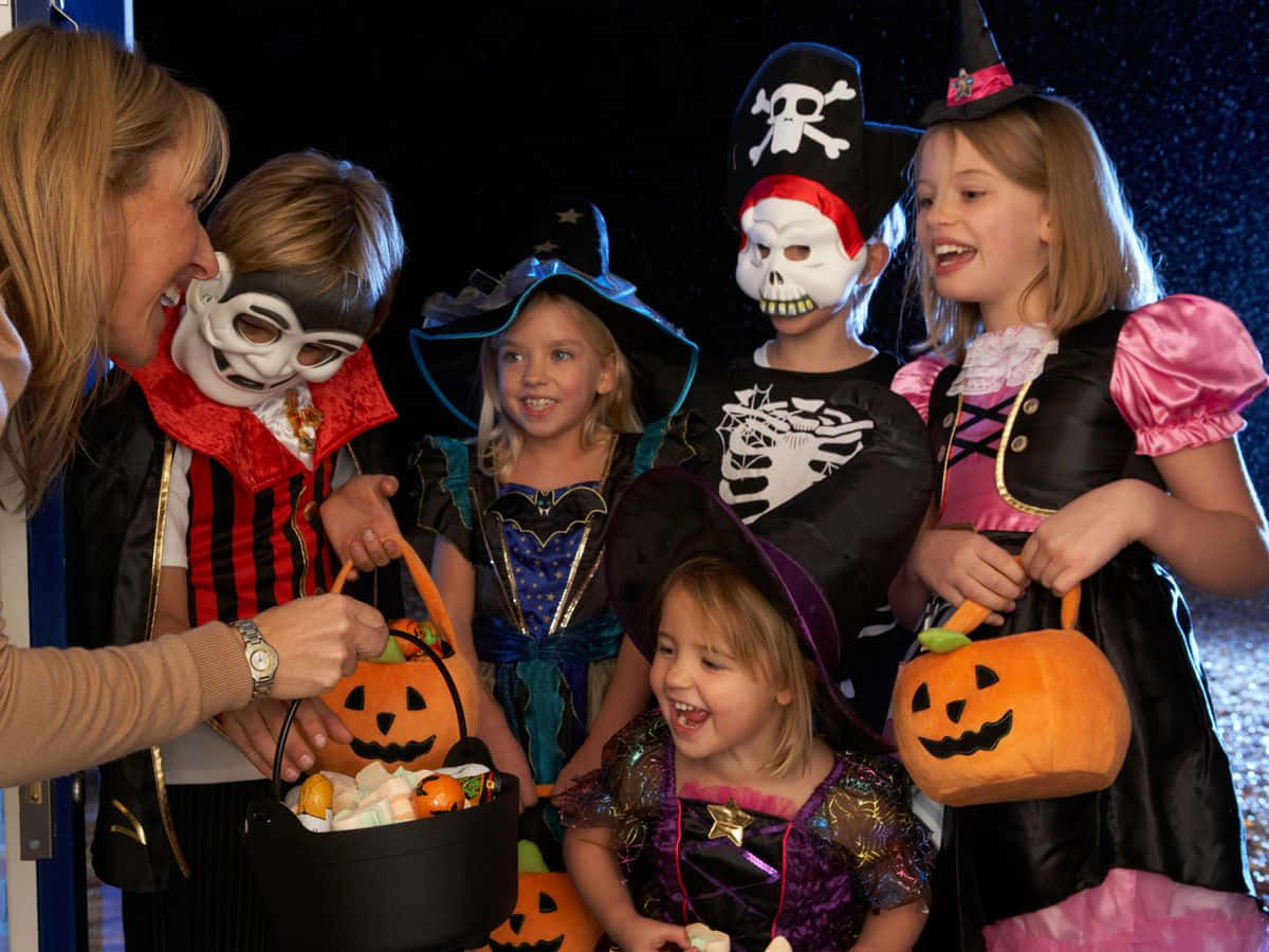 A Group Of Children Dressed In Halloween Costumes