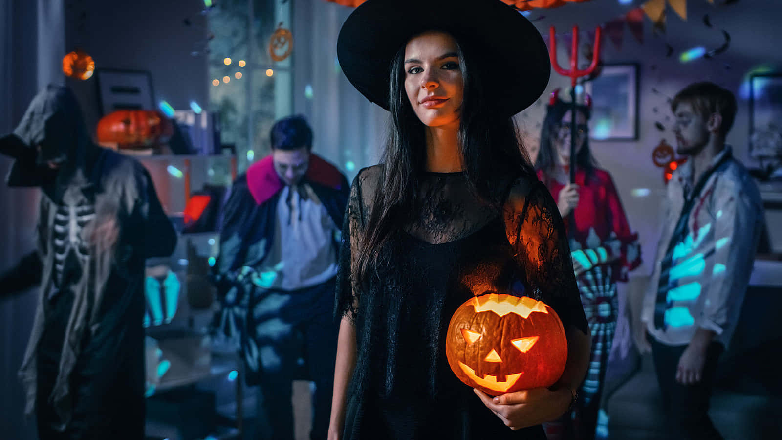 A Woman In A Halloween Costume Holding A Pumpkin