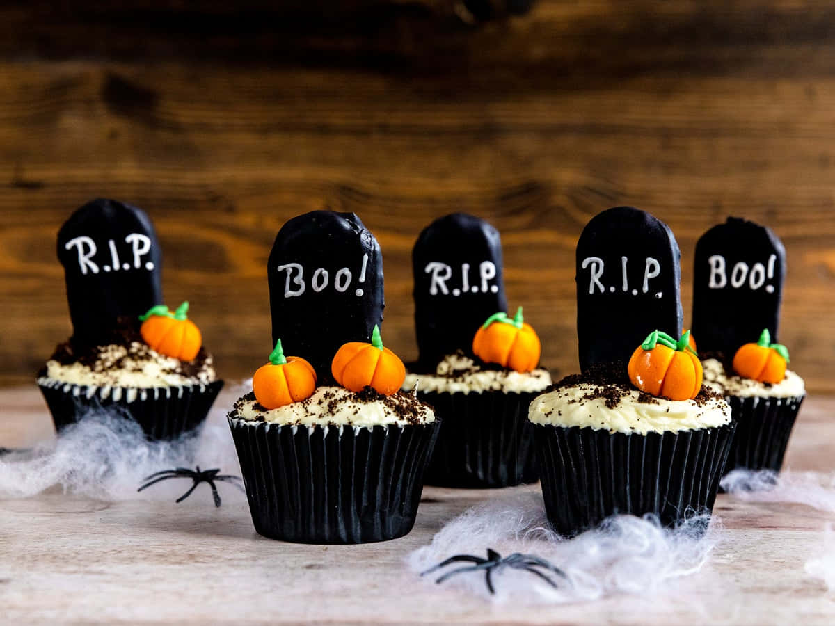 Perfectly-crafted Halloween Cupcakes decorated with orange and black fondant decorations. Wallpaper