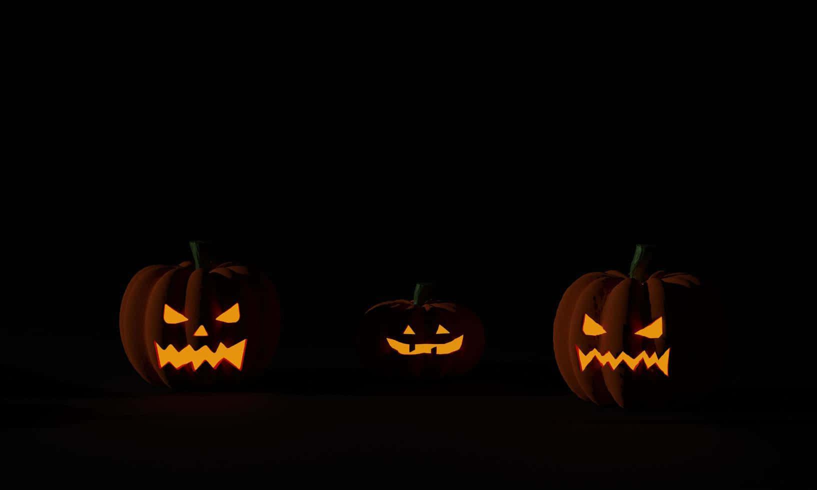 Fondode Pantalla De Tres Calabazas De Halloween En Tonos Oscuros.