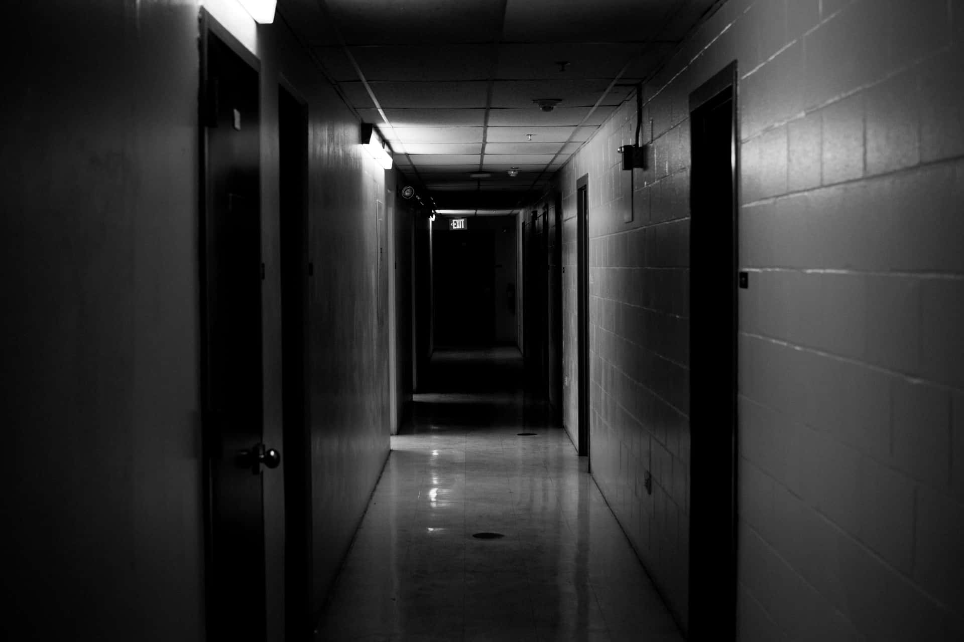 A Dark Hallway With A Light On