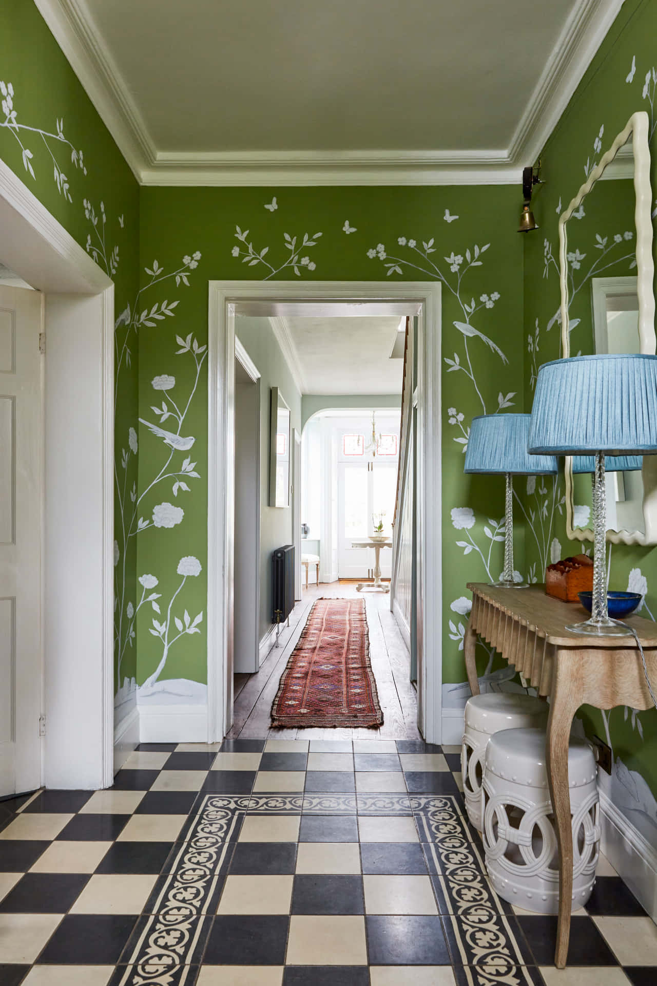 A Hallway With Green Walls And A Checkered Floor