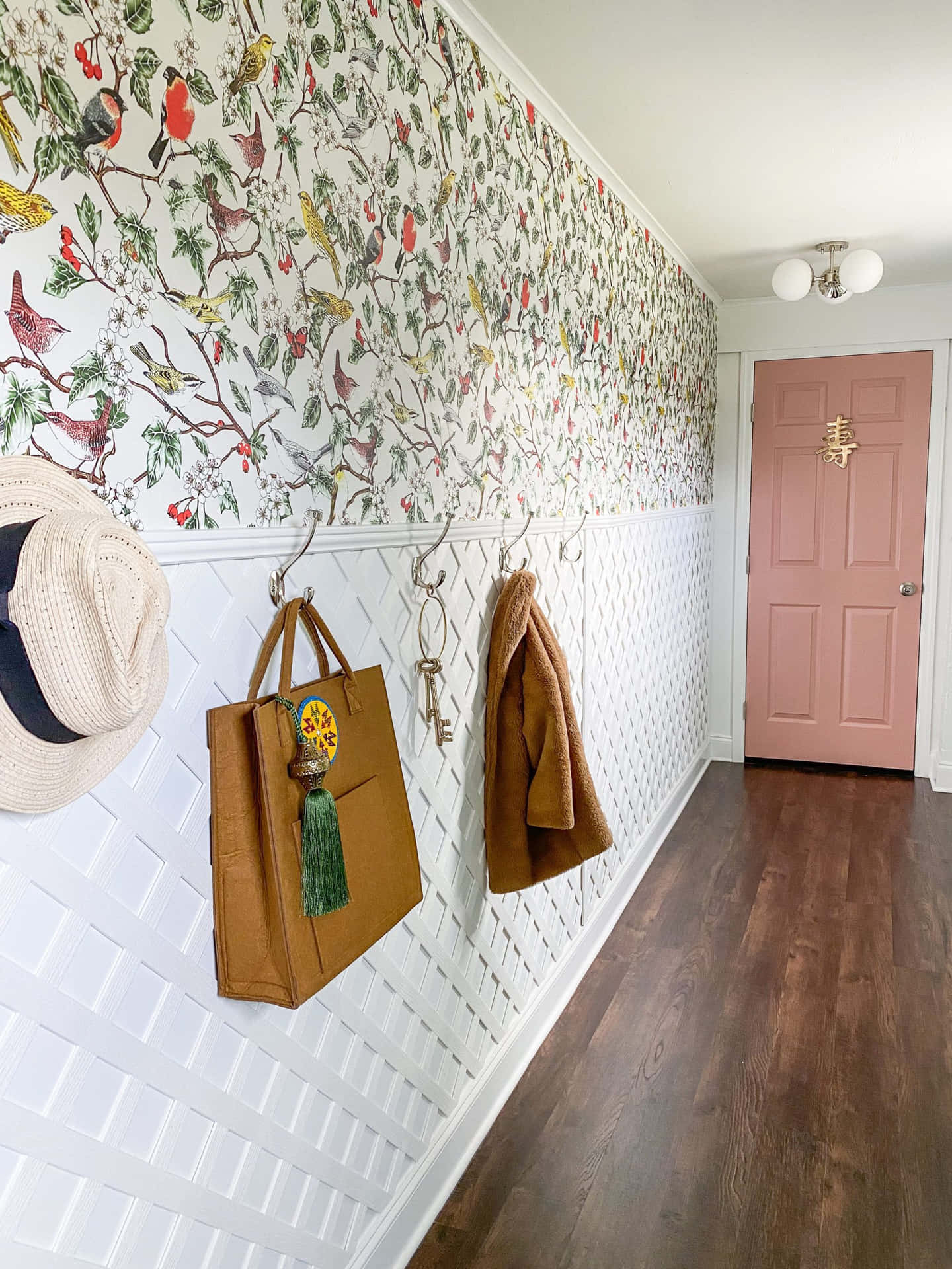 A Hallway With A Pink Coat Rack And A Pink Purse