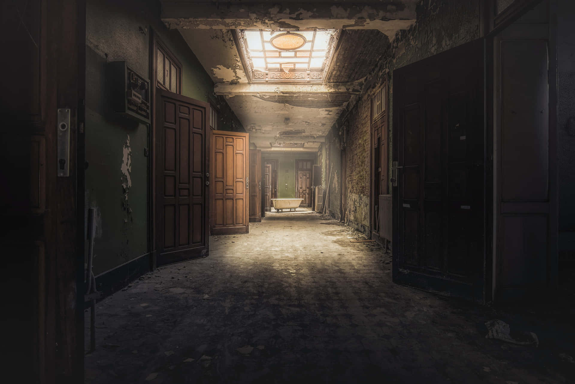 An Abandoned Hallway With A Light Shining Through The Door