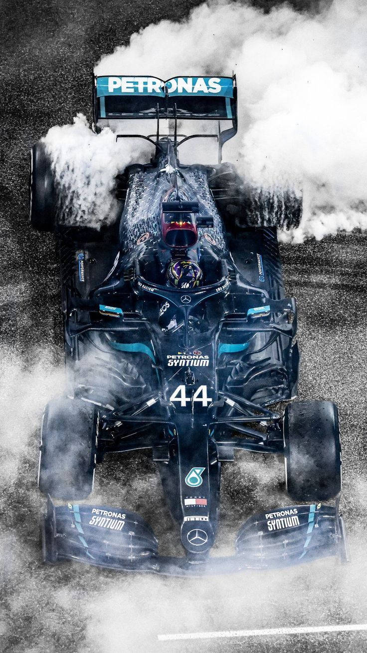 Racing Car Of Lewis Hamilton F1 With Smoke Wallpaper