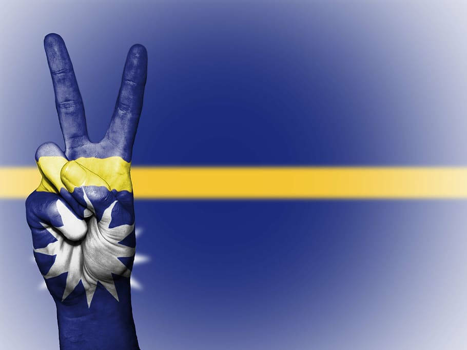 Hand Against Nauru Flag Background