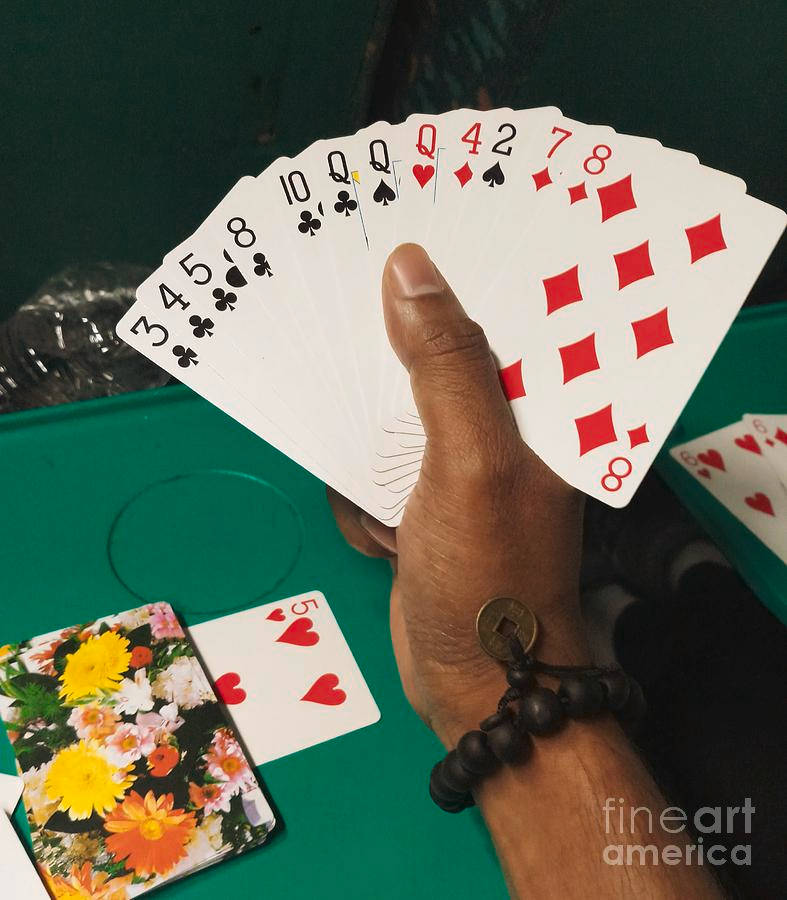 Hand Gripping Rummy Playing Cards Wallpaper