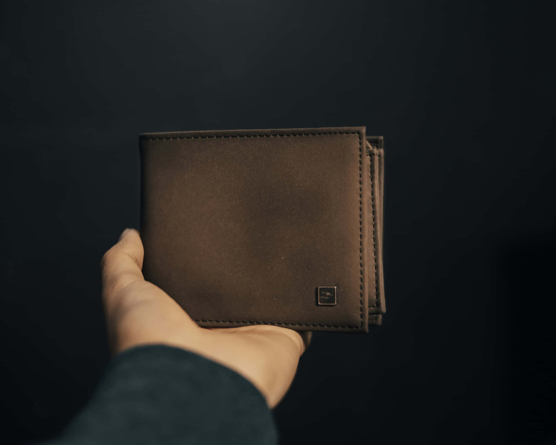 Hand Holding Brown Leather Wallet Wallpaper