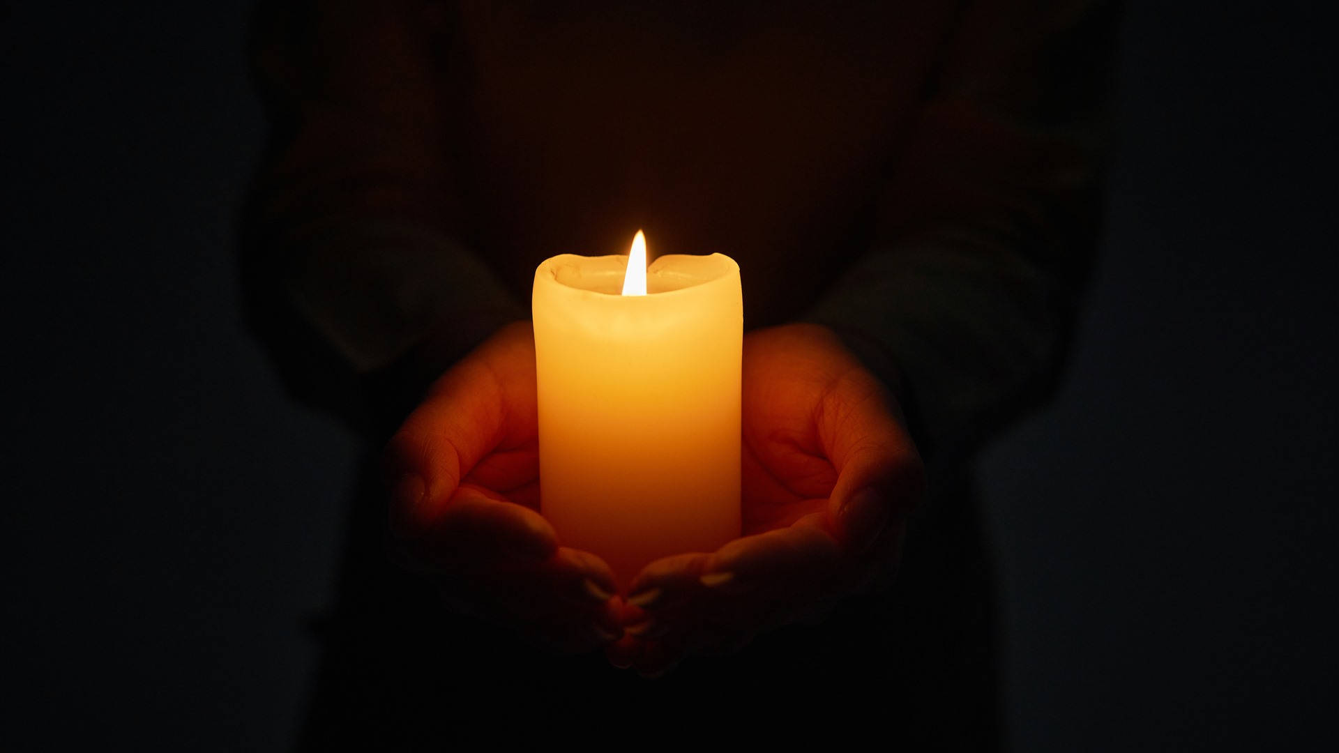 Hand Holding Condolence Candle