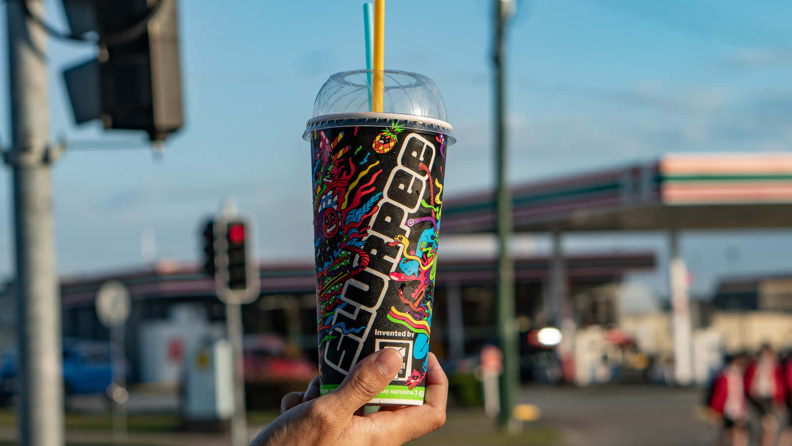 Hand Holding Slurpee Cup Outdoors Wallpaper