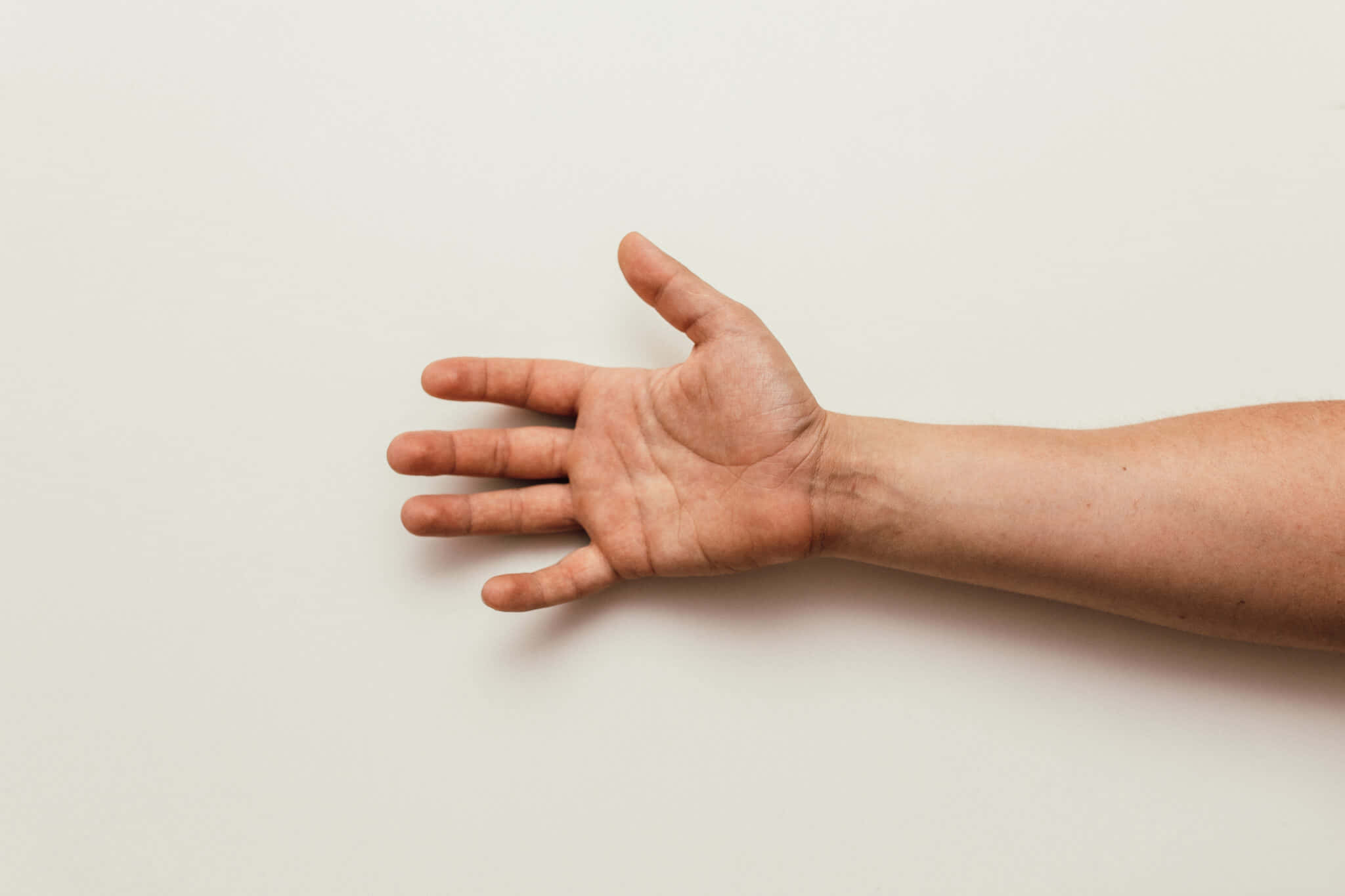 A Man's Hand Reaching Out To The Side