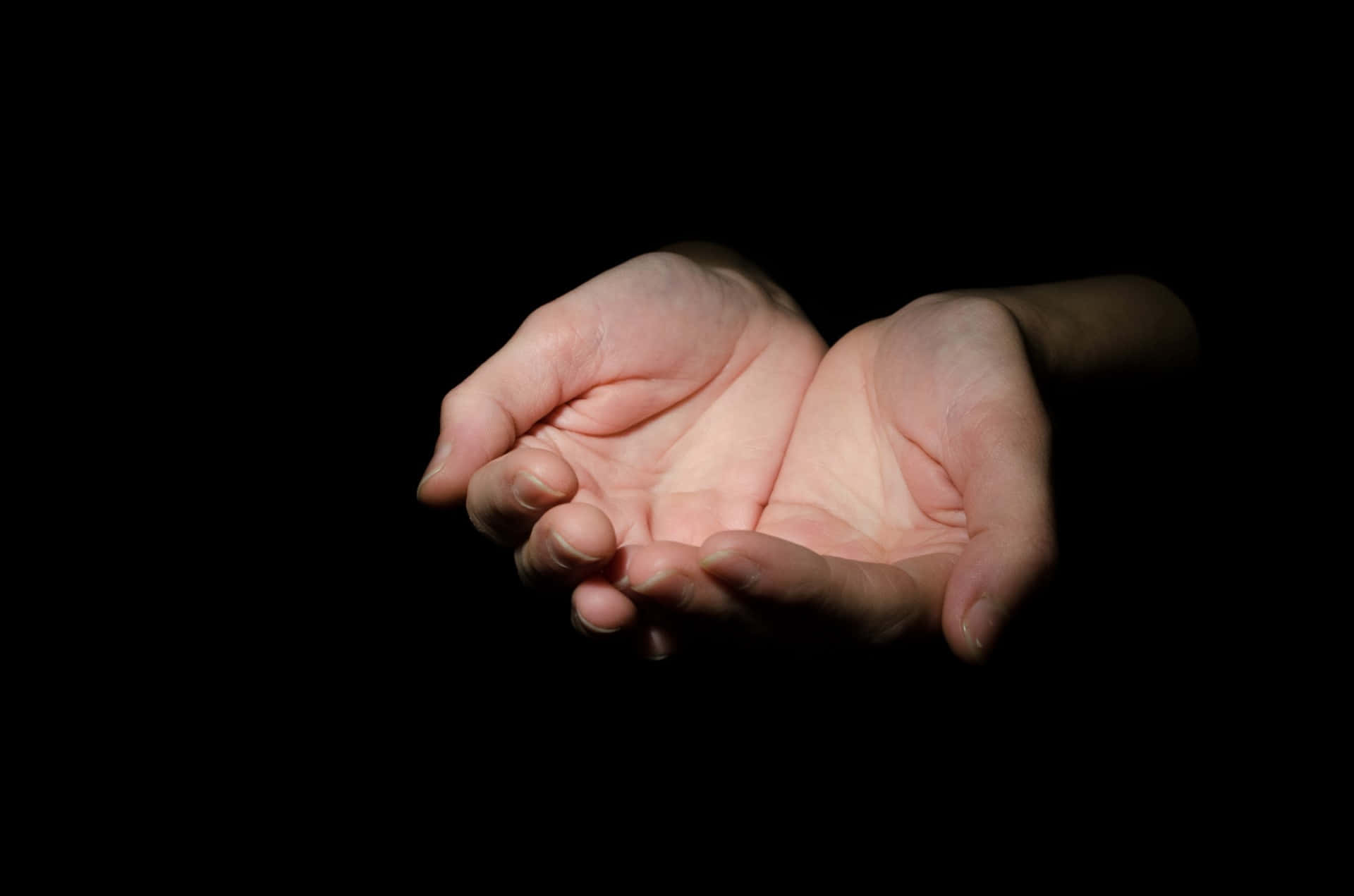 A pair of hands reaching out to each other against an abstract blue-green background