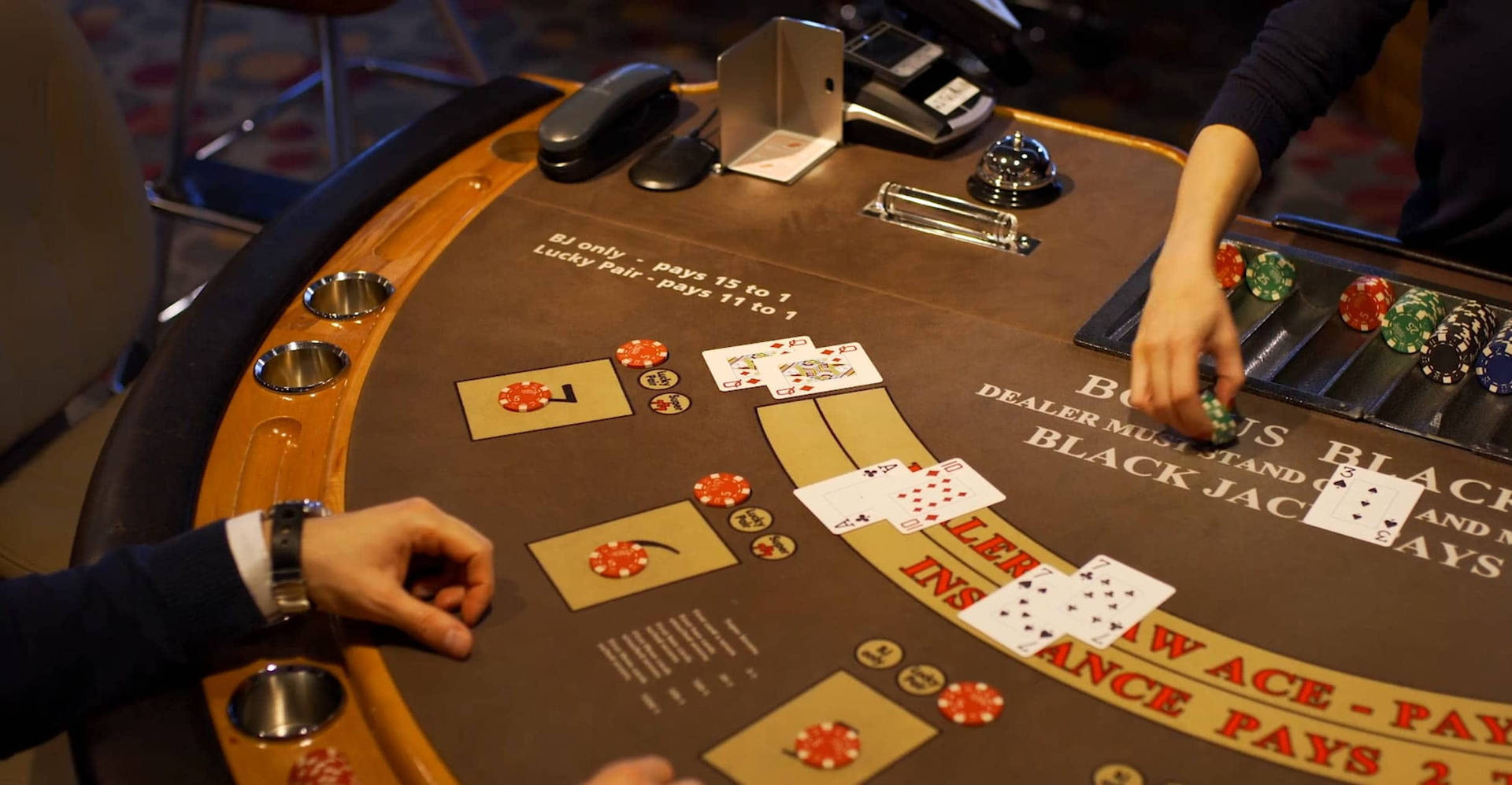Hands Of The Players Brown Table Playing Baccarat Wallpaper