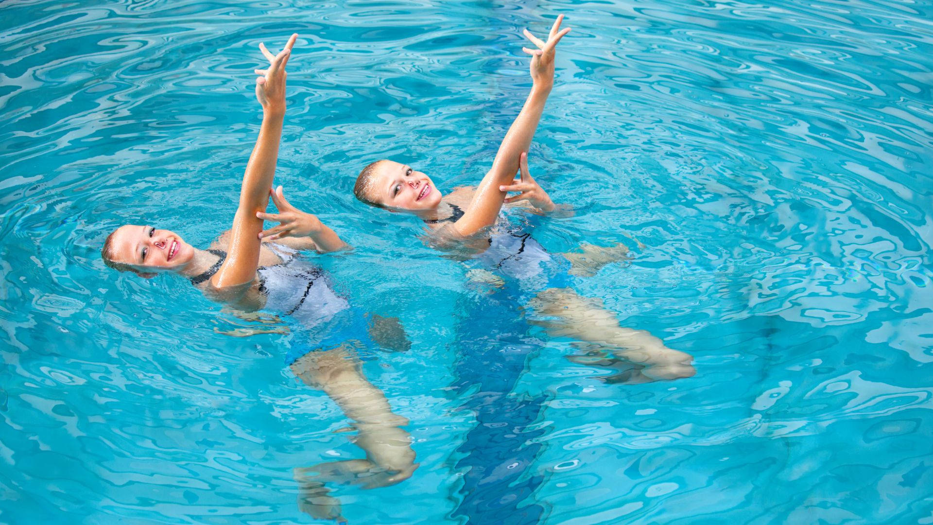 Synchronized Grace - Artistic Swimming Performance Wallpaper