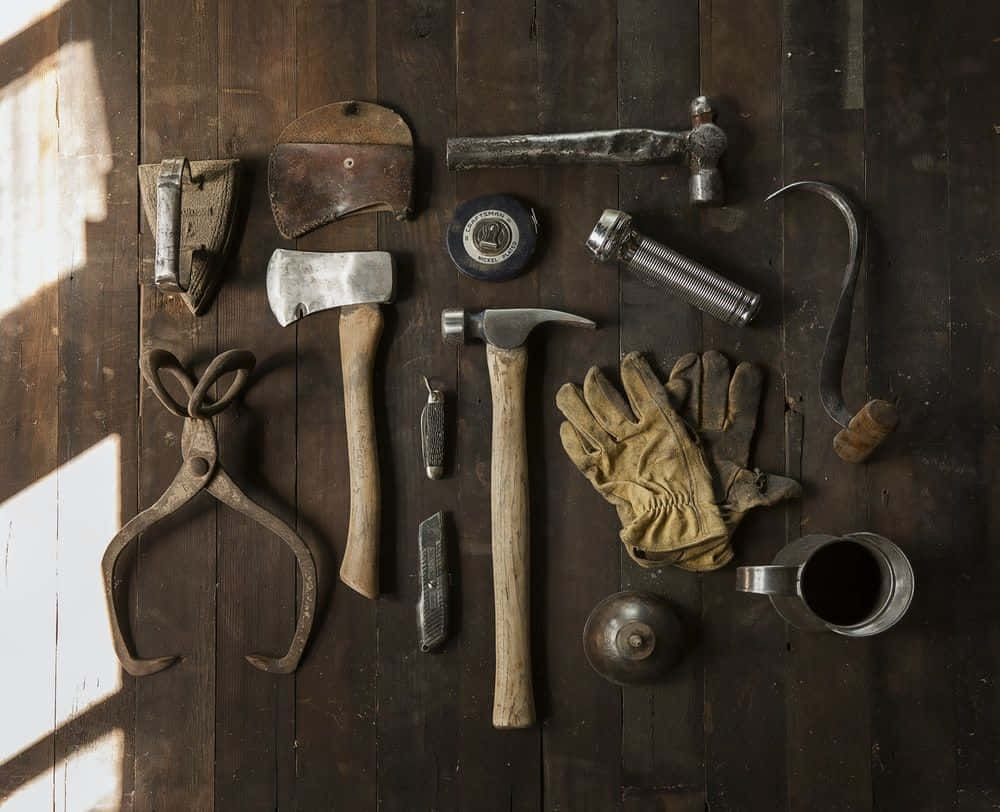 A Collection Of Tools On A Wooden Table