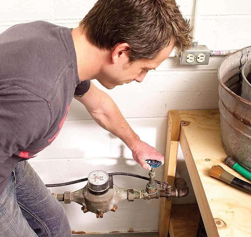 A Man Is Adjusting A Water Pressure Gauge