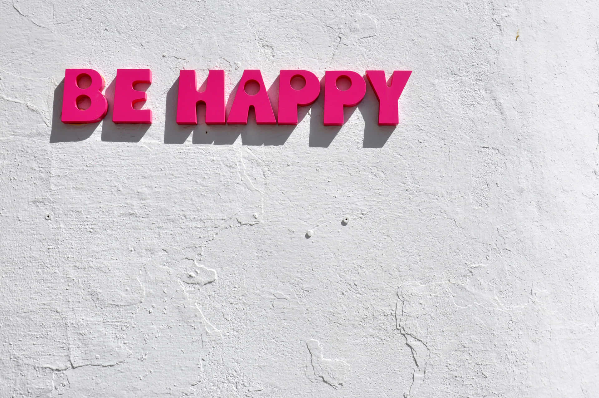 Be Happy Sign On A White Wall Wallpaper