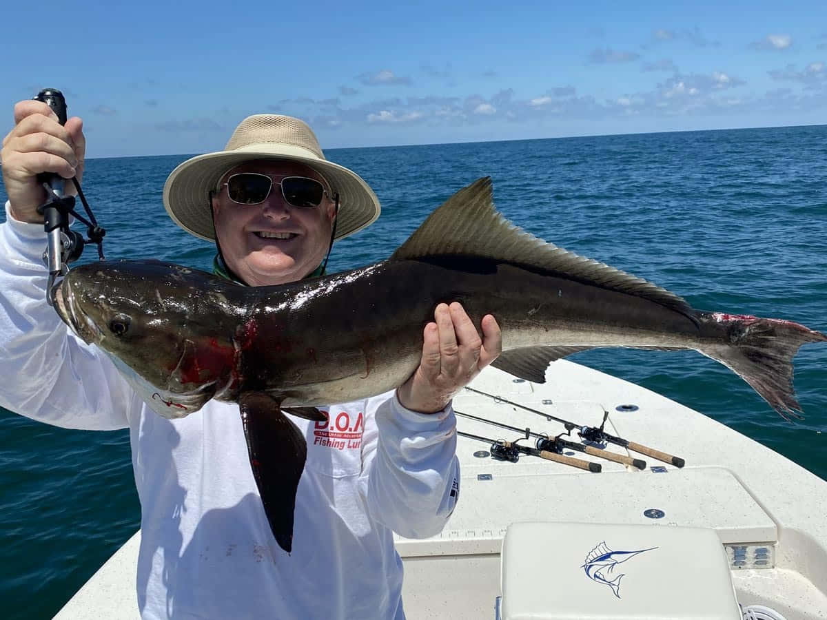 Happy Anglerwith Cobia Catch Wallpaper