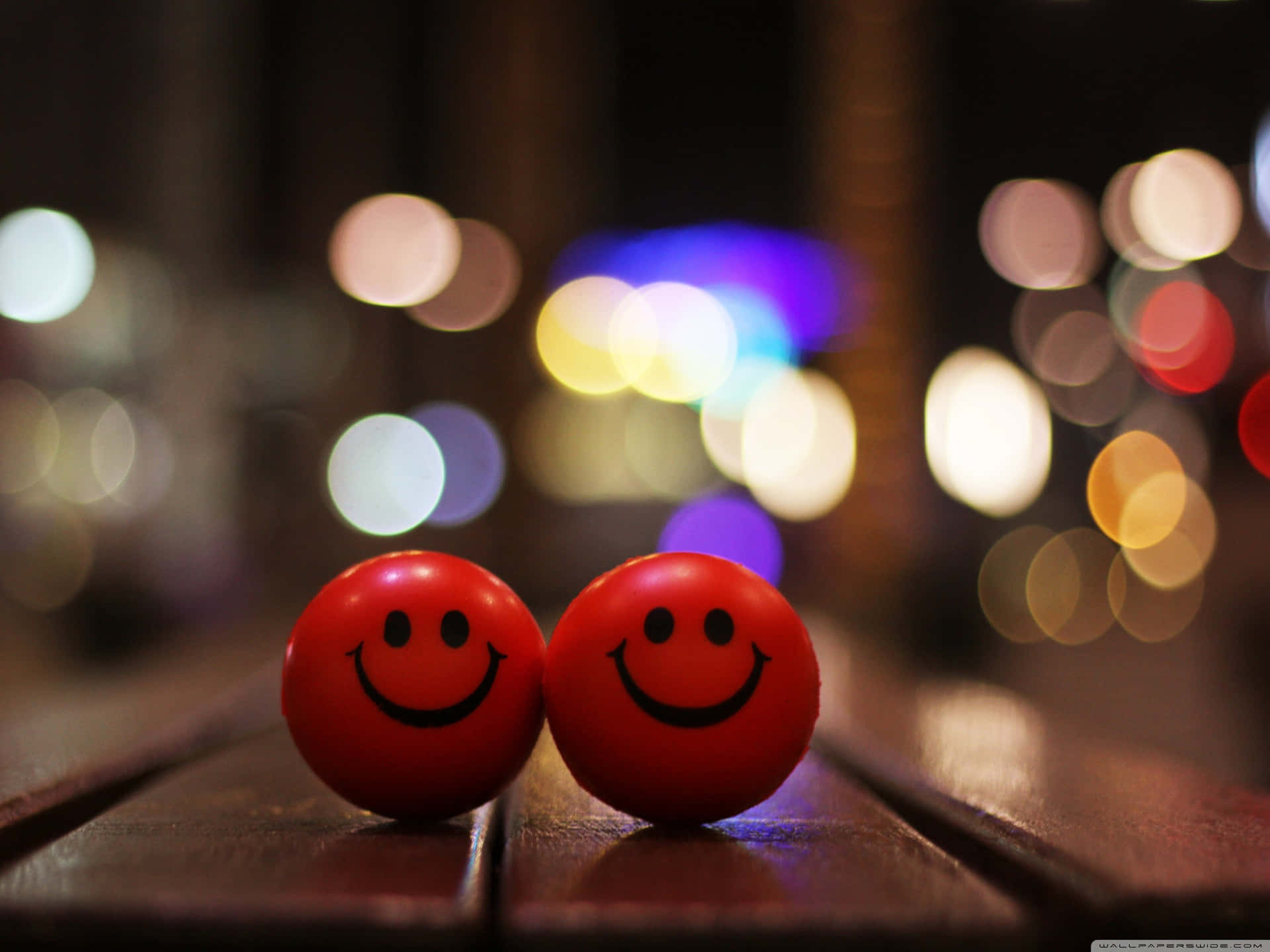 Two Red Balls On A Wooden Table Wallpaper