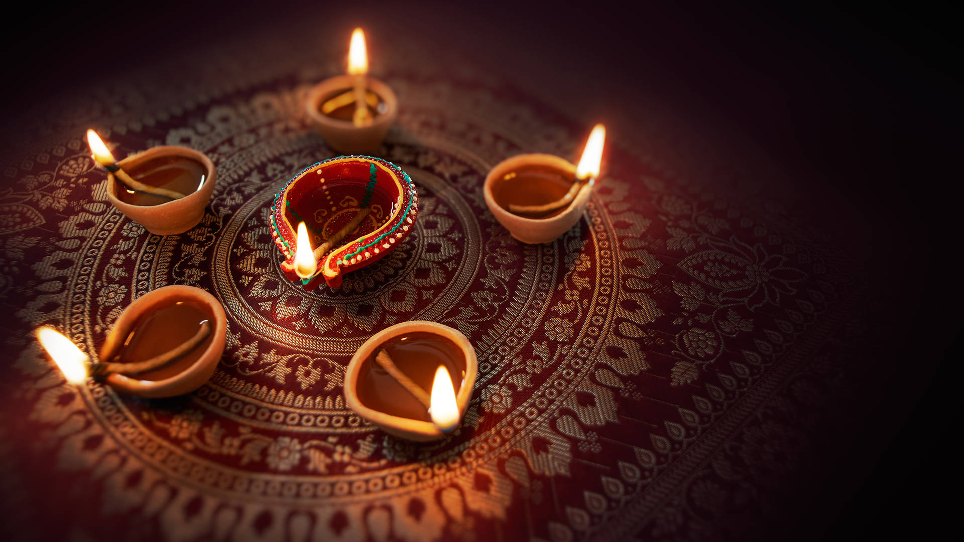 Happy Diwali Oil Lamps On Carpet Wallpaper