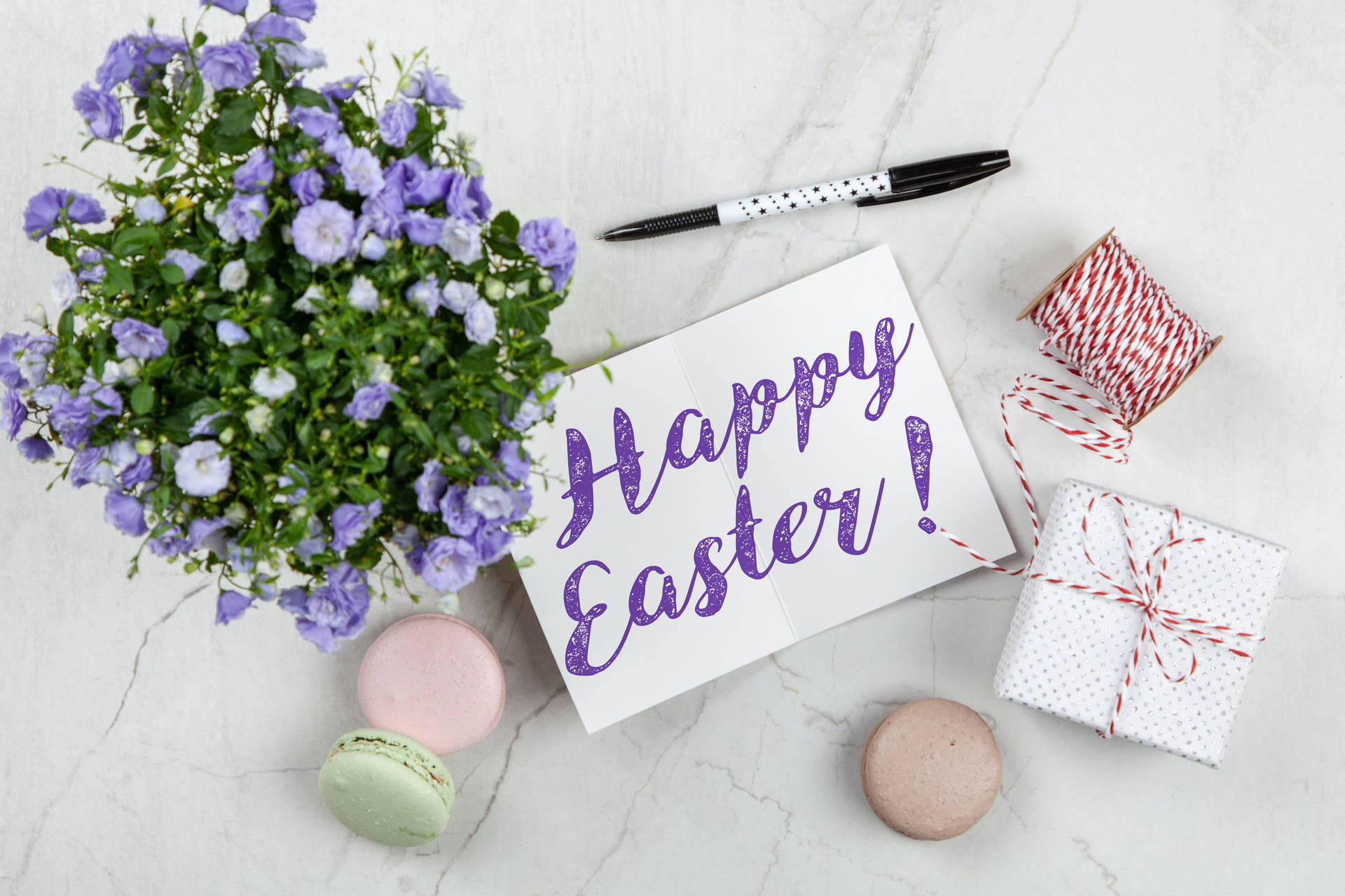 Happy Easter Flat Lay Violet Calligraphy With Bellflowers Wallpaper