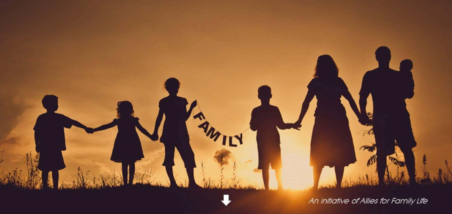 Family Silhouettes At Sunset