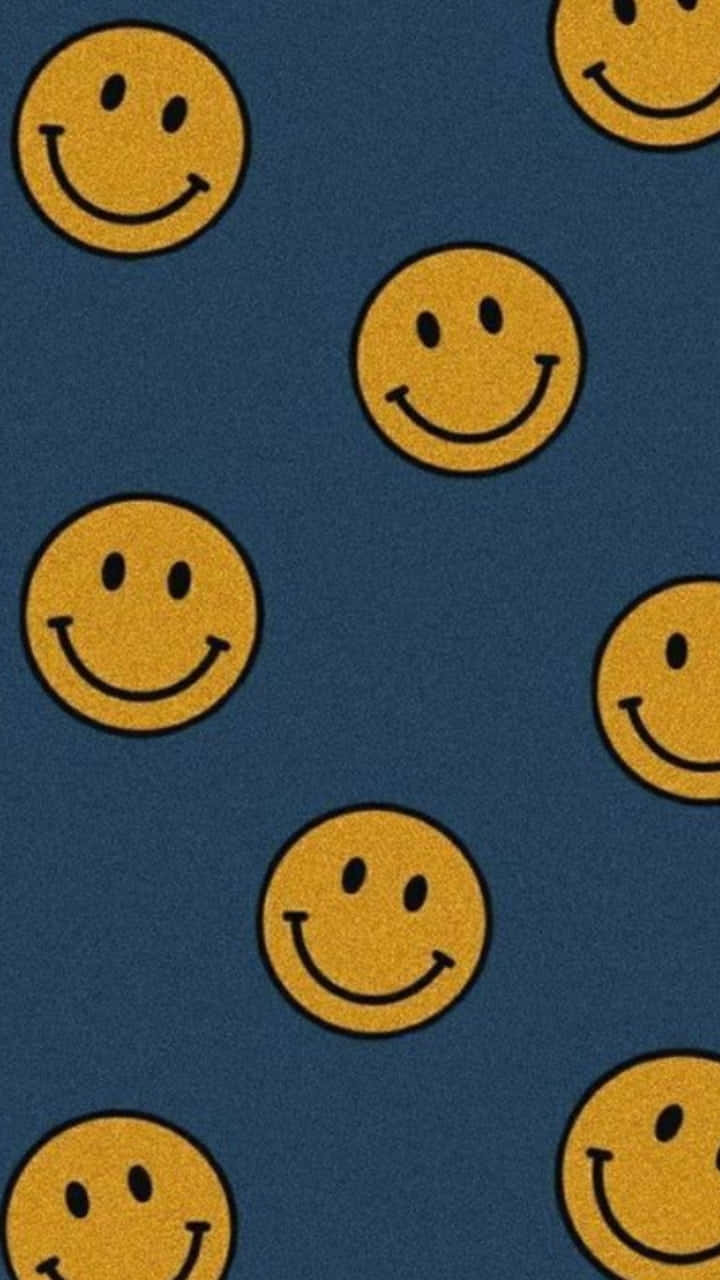 En blå tæppe med glade ansigter på det. Wallpaper