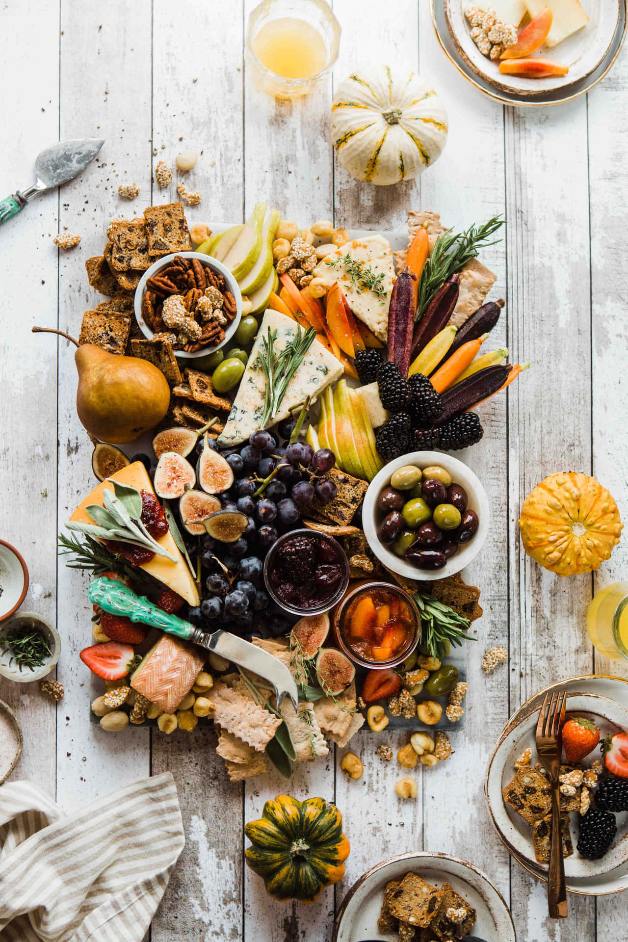 a platter of cheese, fruit, nuts and other foods Wallpaper