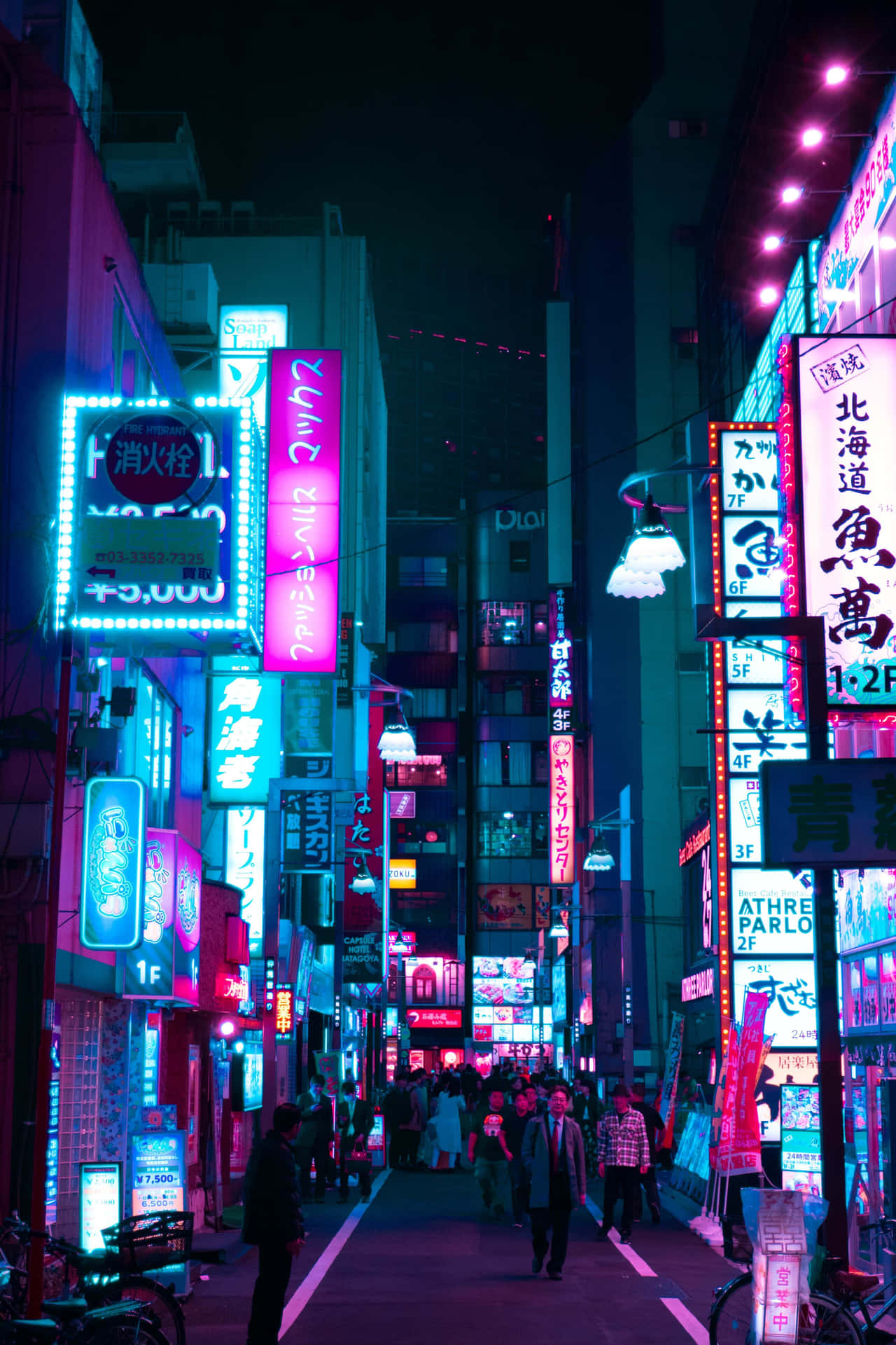 A City Street With Neon Signs Wallpaper