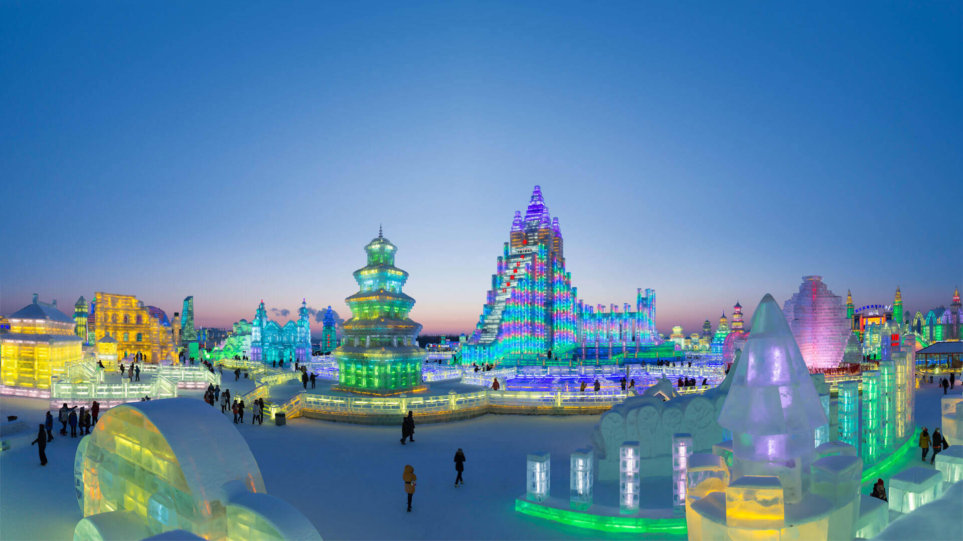 Breathtaking view of the vibrant ice structures at the Harbin Ice Festival Wallpaper