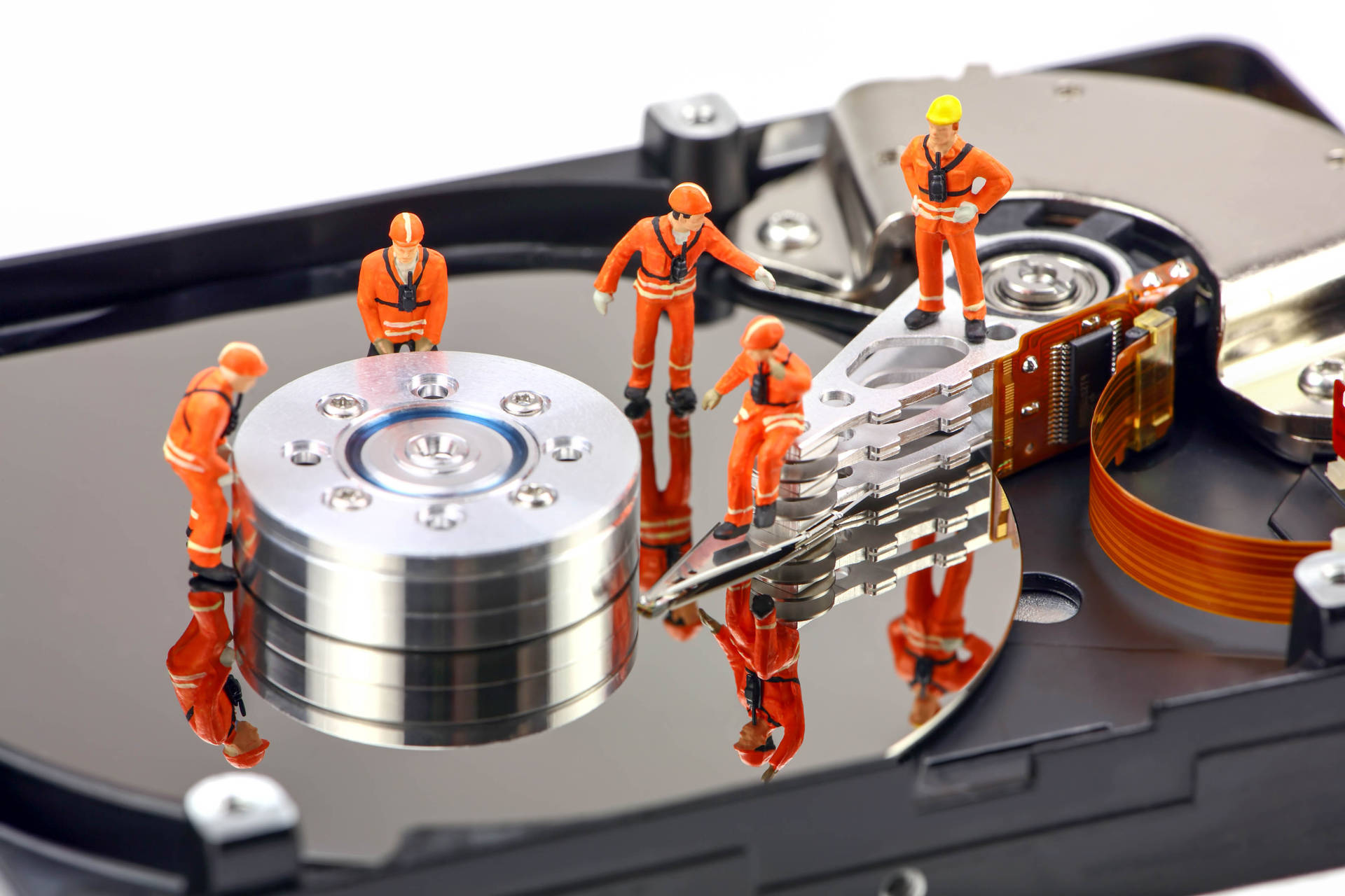 Hard Drive Disk With Miniature Worker Toys Wallpaper