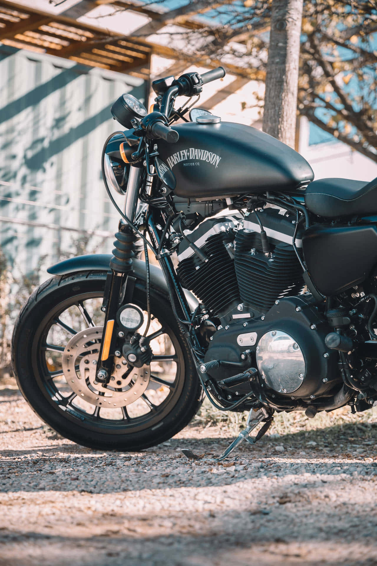 En sort motorcykel parkeret på en jordvej Wallpaper