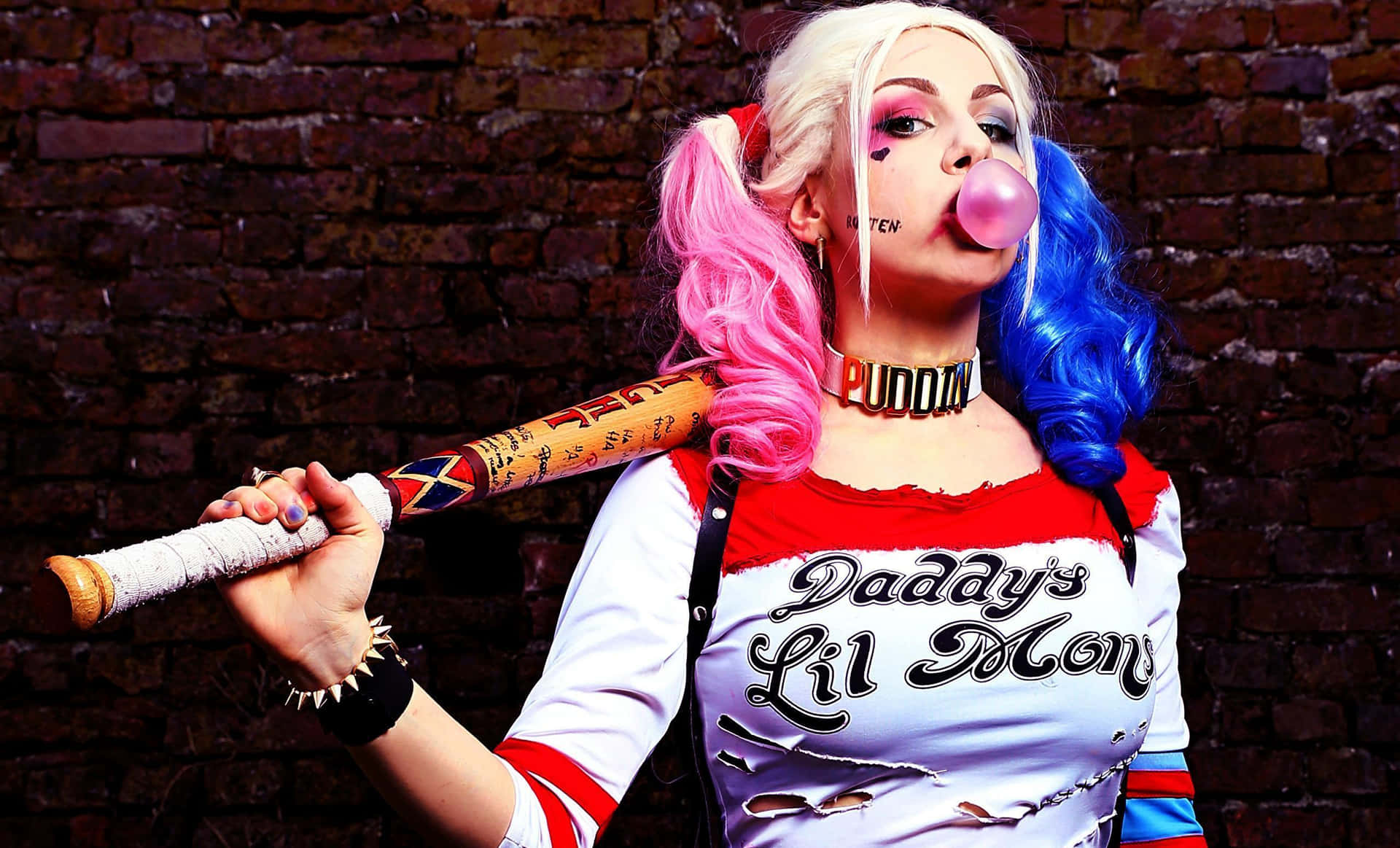 Harley Quinn holding her iconic baseball bat in a powerful stance Wallpaper