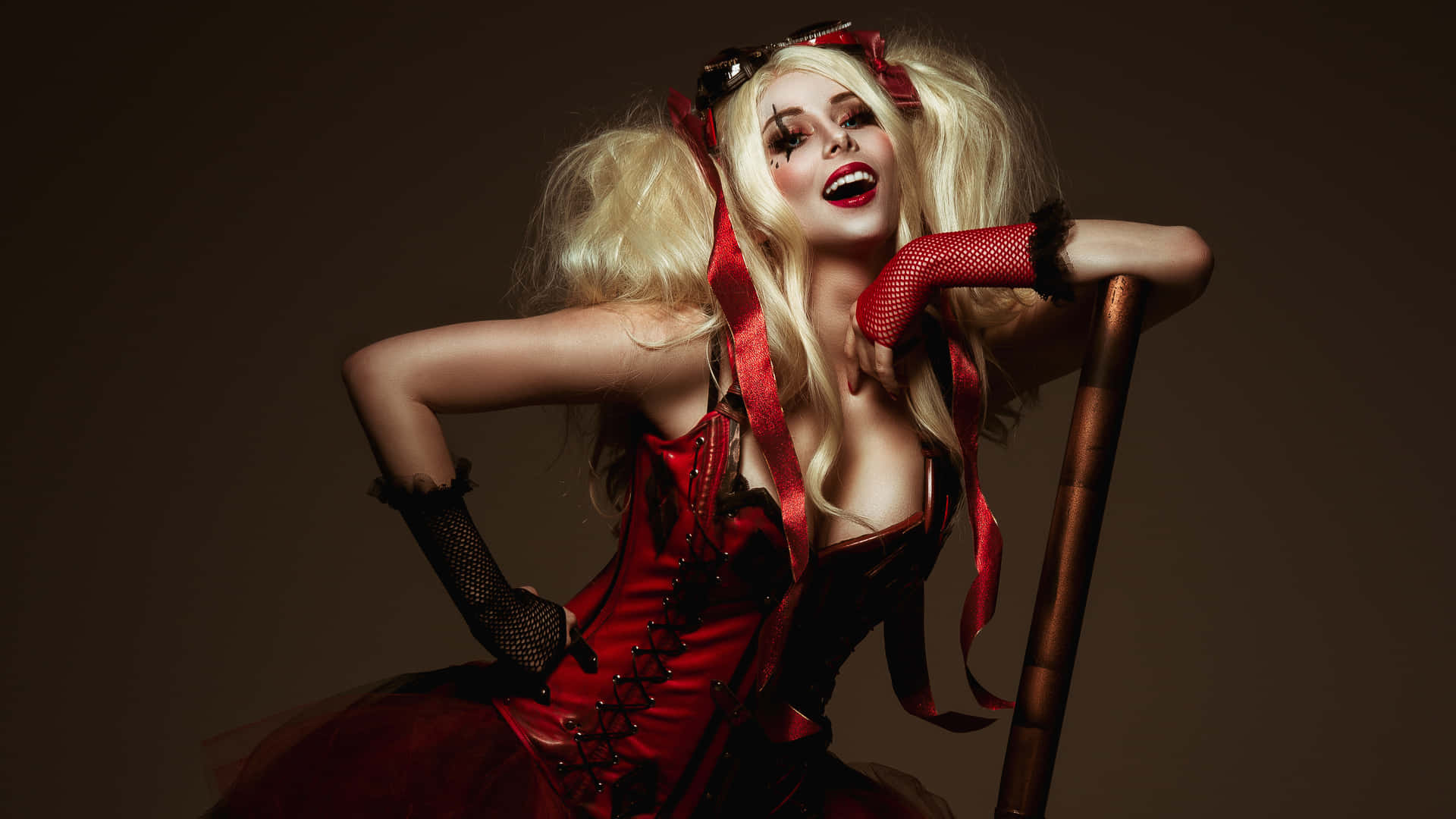 Stunning Harley Quinn Cosplay poses fiercely in a realistic costume. Wallpaper