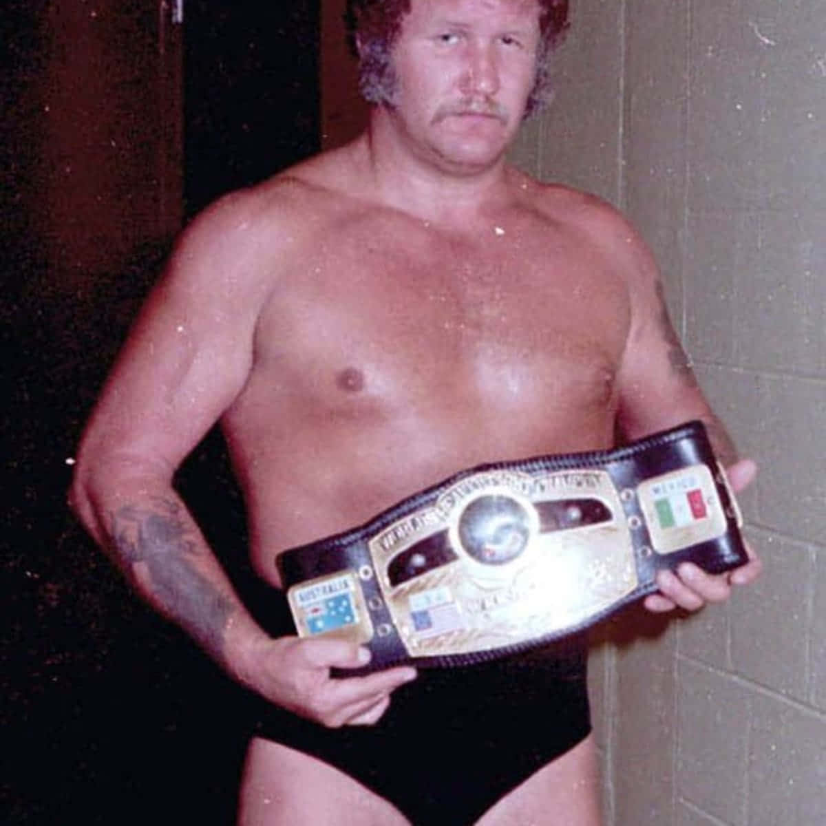 Harley Race proudly displaying the NWA Championship belt Wallpaper