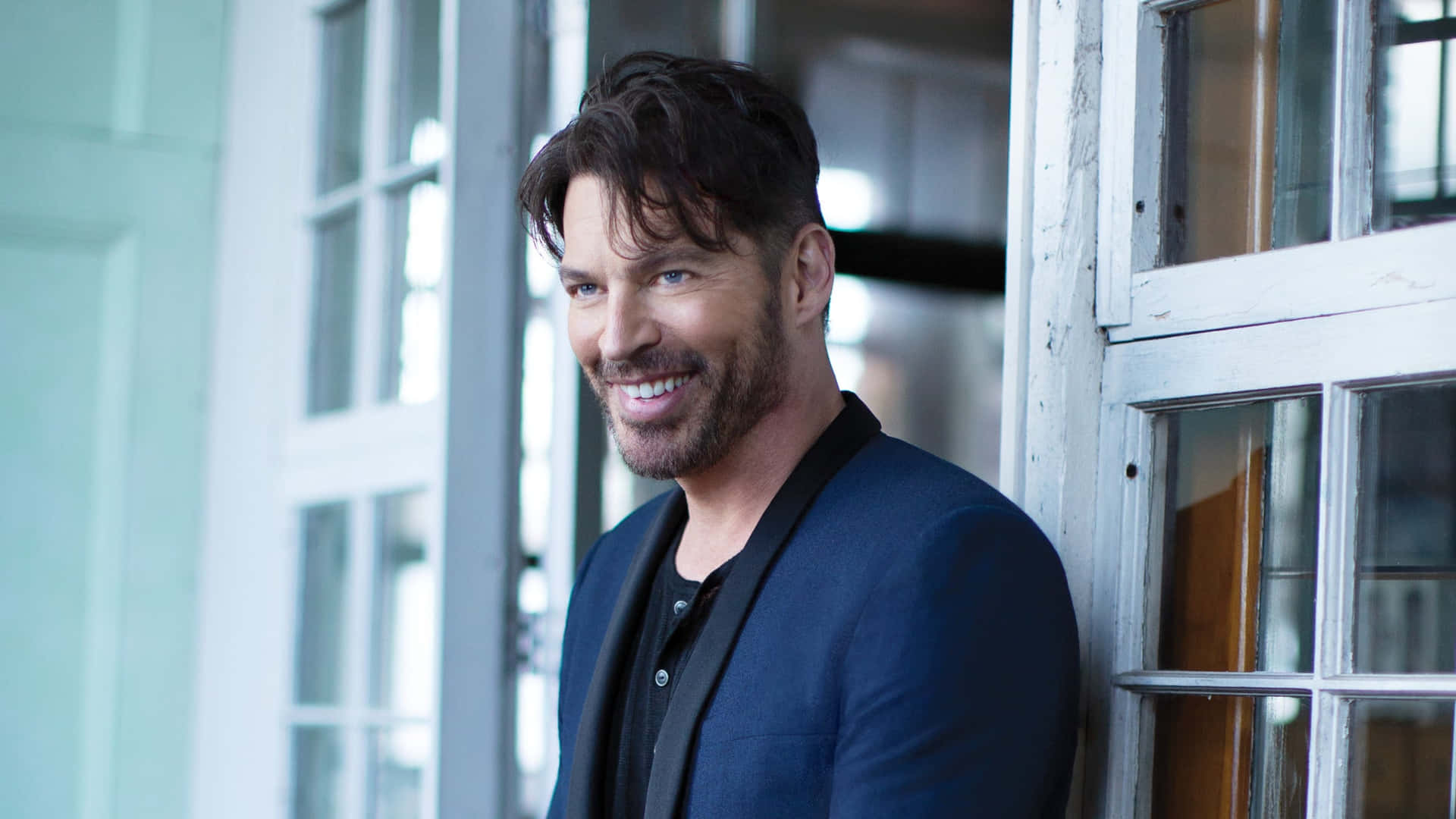 A smiling Harry Connick Jr on stage during a performance Wallpaper