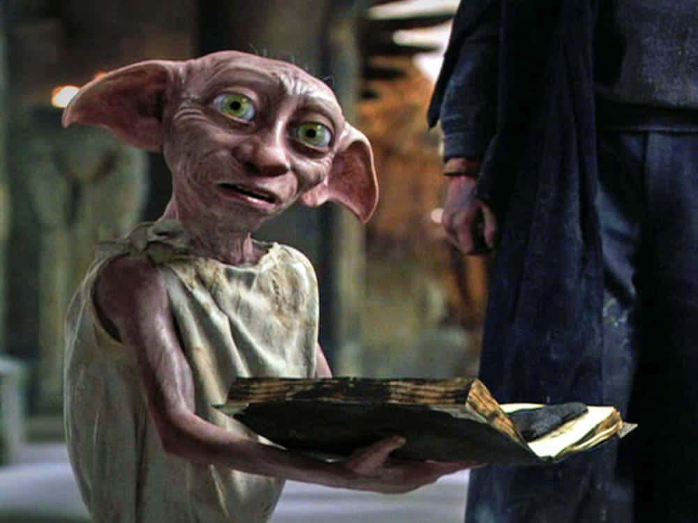 "Dobby the house-elf delightedly watches Harry Potter and friends escape danger." Wallpaper