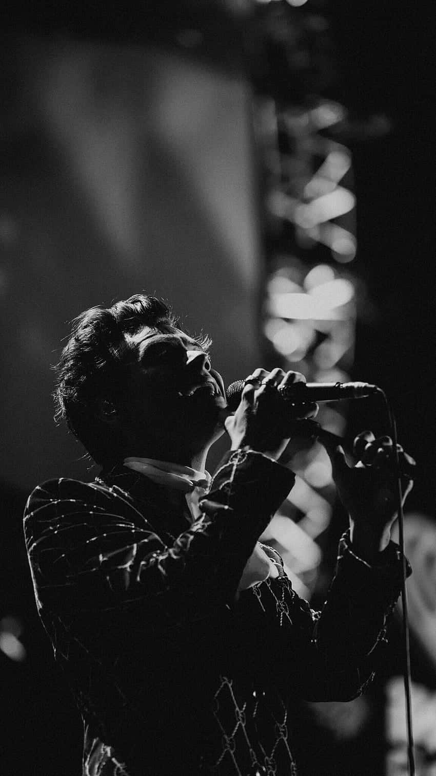 Harry Styles Black And White Background On Stage Wallpaper