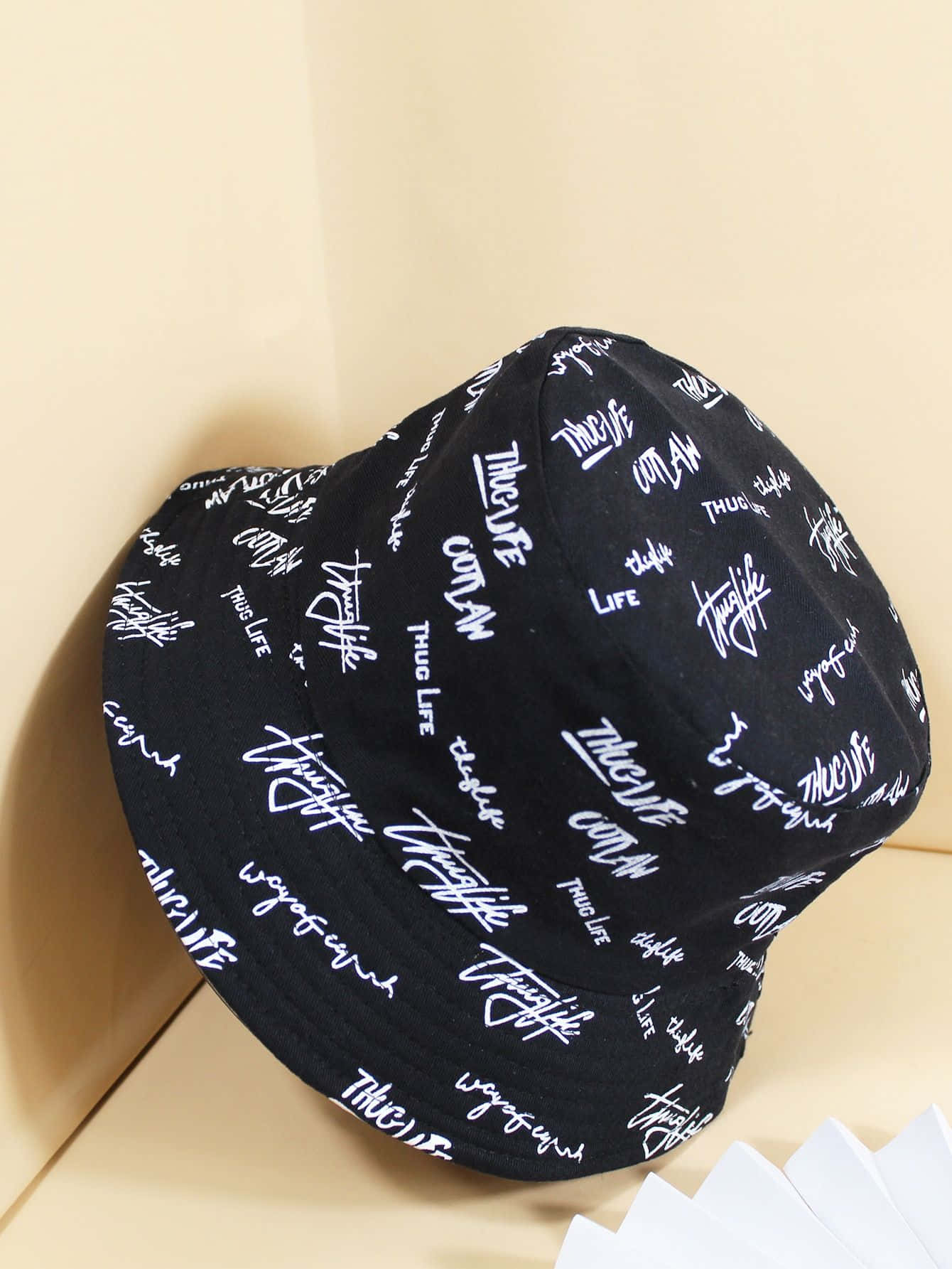 Stylish hat with a classic black ribbon on a white surface. Wallpaper