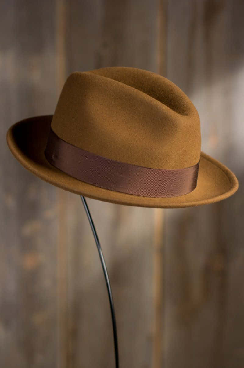 Stylish Black Hat on a Wooden Table Wallpaper