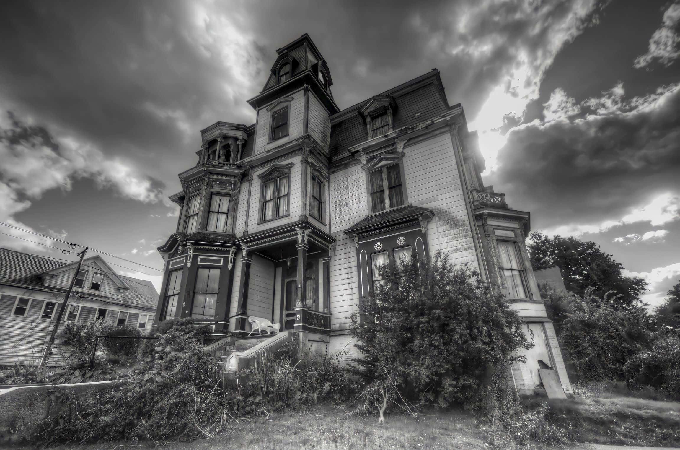A Black And White Photo Of An Old Victorian House