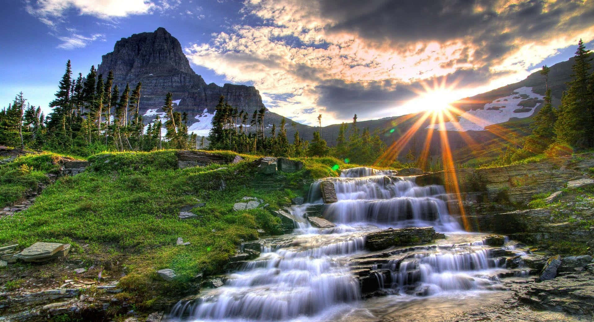 a waterfall in the mountains Wallpaper