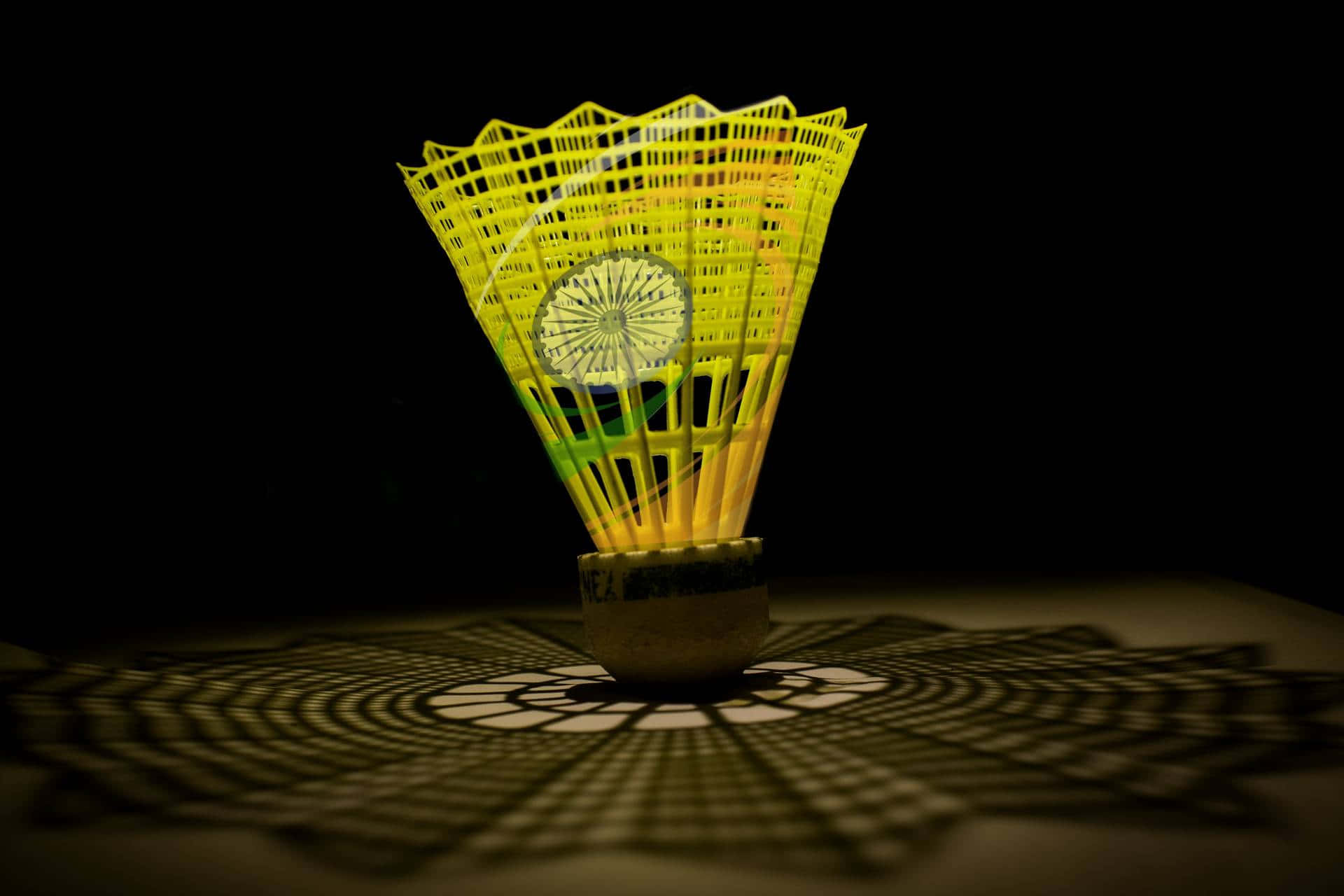 A Badminton Racket With A Yellow Design On It