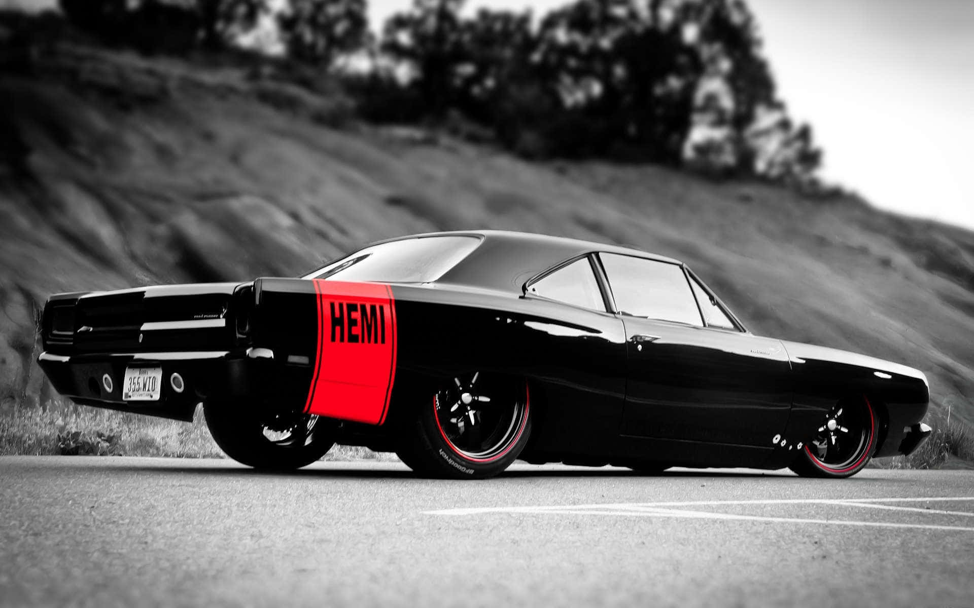 A Black And Red Muscle Car Is Parked On The Side Of The Road