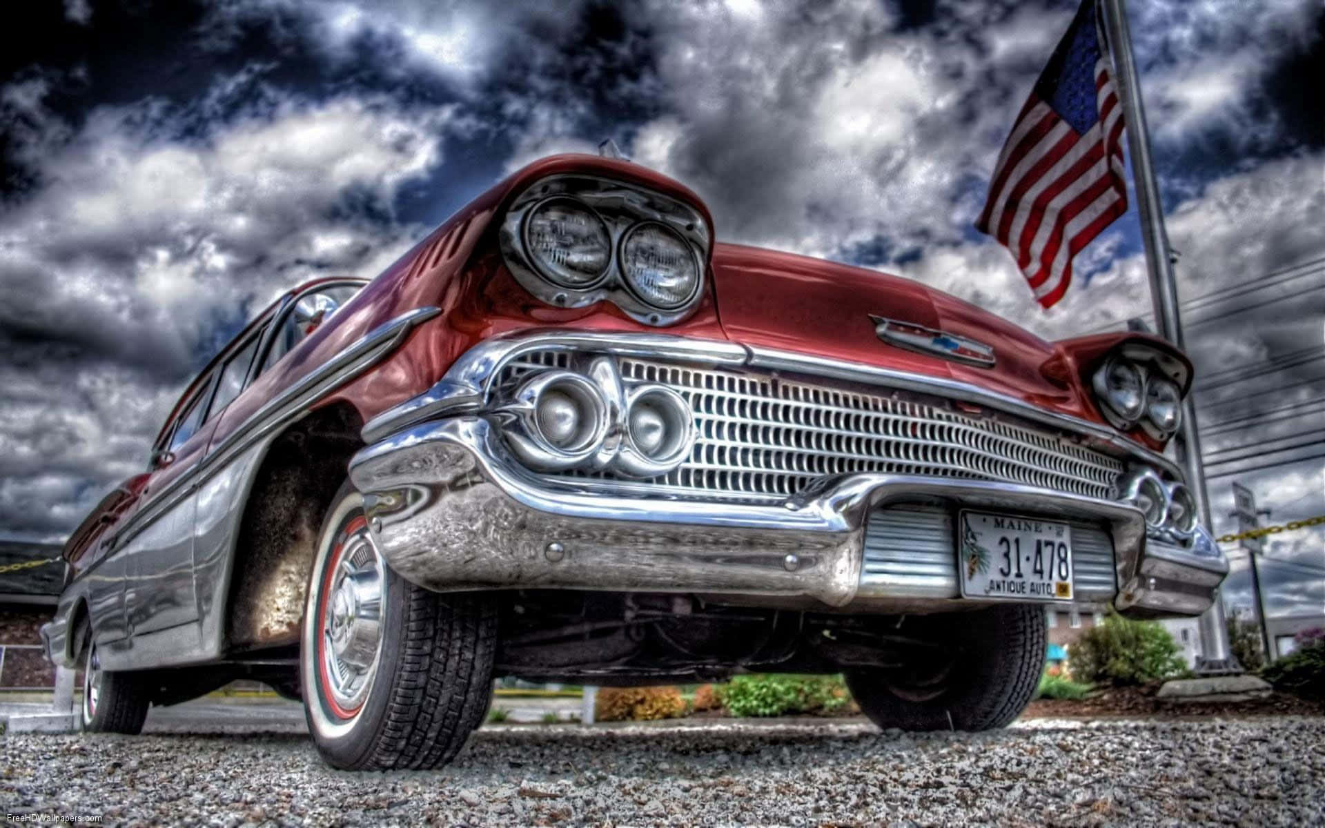 A Classic Car Parked In Front Of A Cloudy Sky