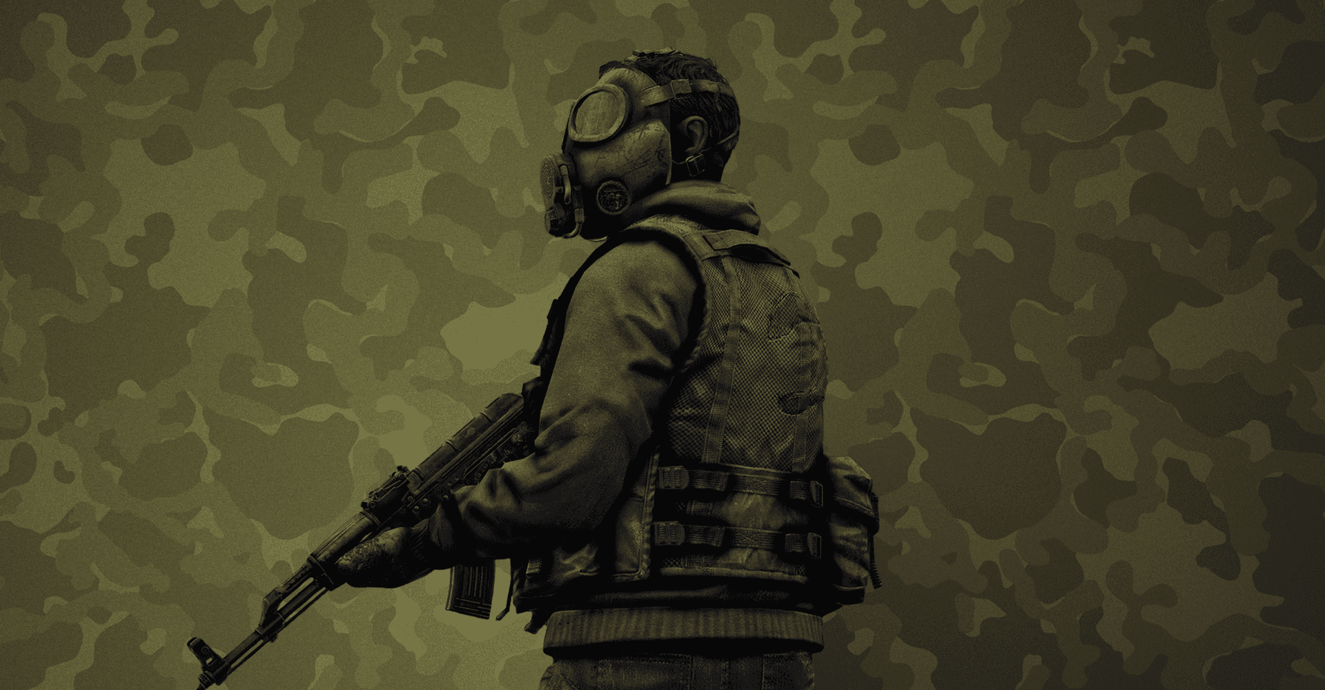 A Soldier In A Gas Mask Is Standing In Front Of A Camouflage Background