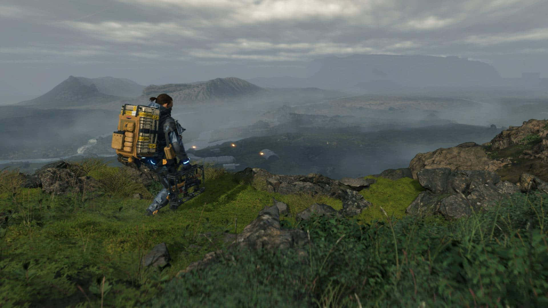 A Man Is Walking On A Hill With A Backpack
