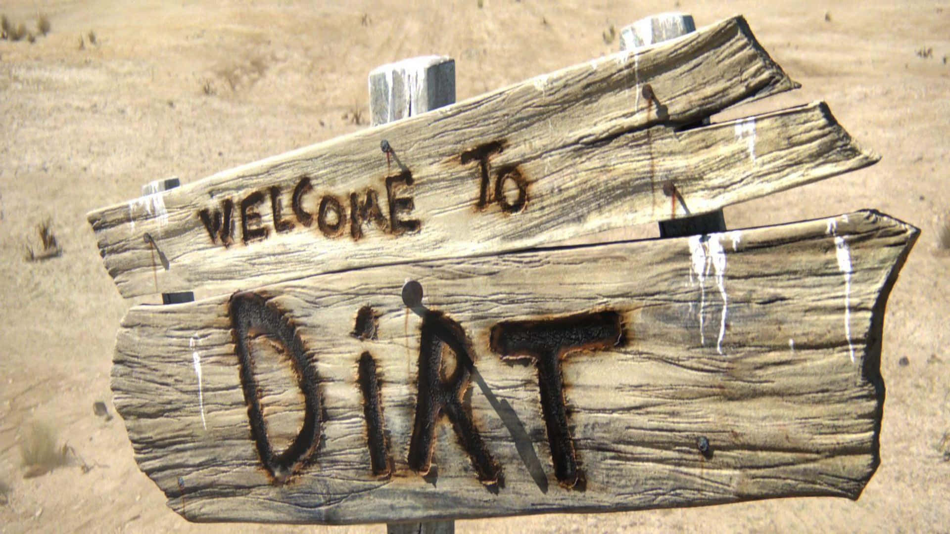 A Wooden Sign That Says Welcome To Dirt