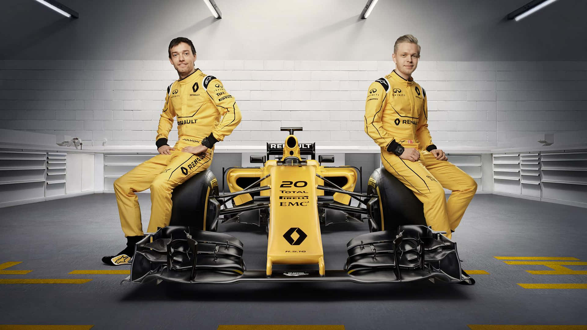 Two Men In Yellow Suits Pose Next To A Yellow Racing Car